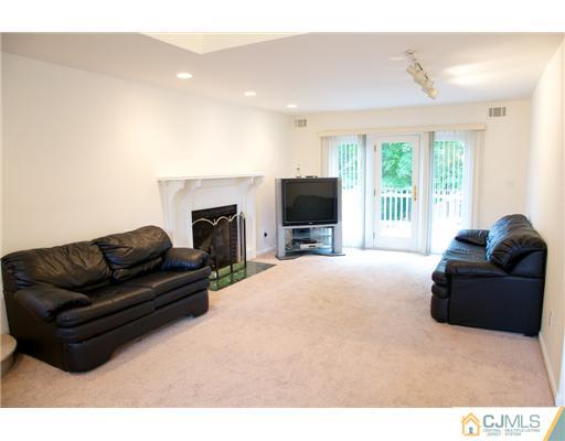 5 Beech Lane Edison, NJ 08820 - Photo 3 of 25 a living room with furniture a fireplace and a flat screen tv