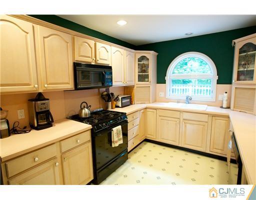 5 Beech Lane Edison, NJ 08820 - Photo 23 of 25 a kitchen with stainless steel appliances granite countertop a stove a sink and a microwave