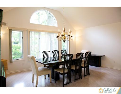 5 Beech Lane Edison, NJ 08820 - Photo 5 of 25 a dining room with furniture a rug and a chandelier