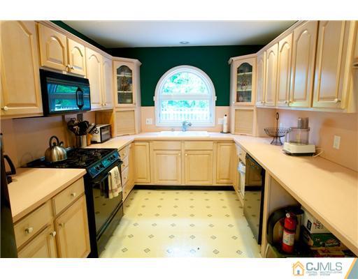 5 Beech Lane Edison, NJ 08820 - Photo 6 of 25 a kitchen with a sink a stove and cabinets