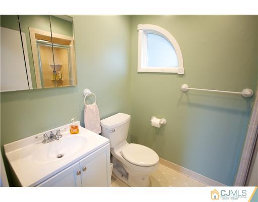 5 Beech Lane Edison, NJ 08820 - Photo 10 of 25 a bathroom with a sink mirror and toilet