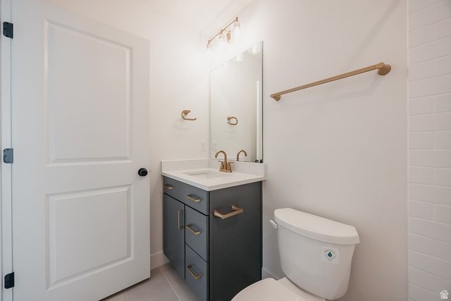 5902 Canyon Rim Road, Unit 620 Lehi, UT 84048 - Photo 58 of 78 Bathroom featuring a contemporary dark grey vanity with gold-tone hardware, a white countertop, and a rectangular undermount sink