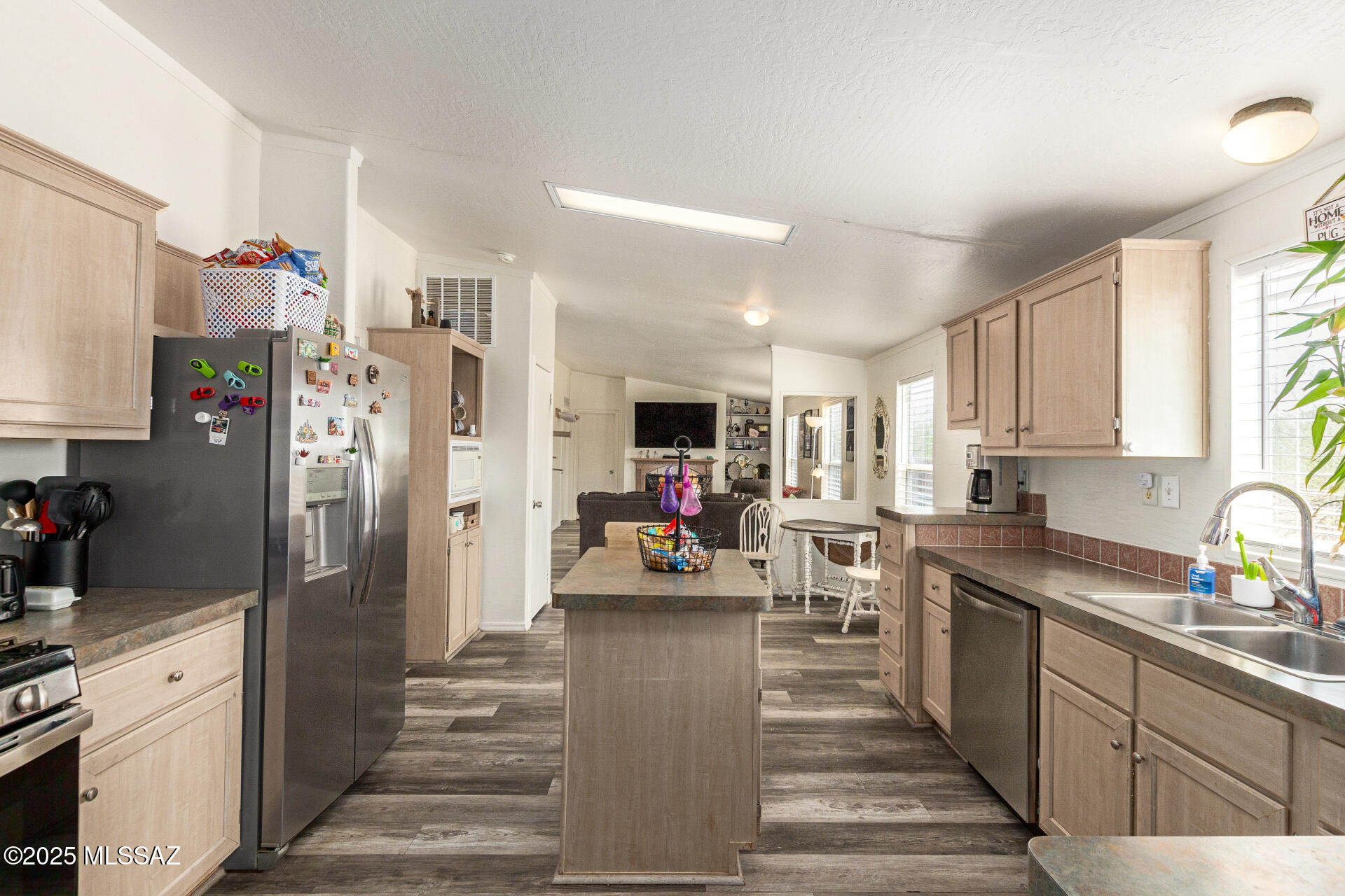 5386 North Whitetail Road Marana, AZ 85653 - Photo 18 of 33 a kitchen with stainless steel appliances a refrigerator sink and cabinets