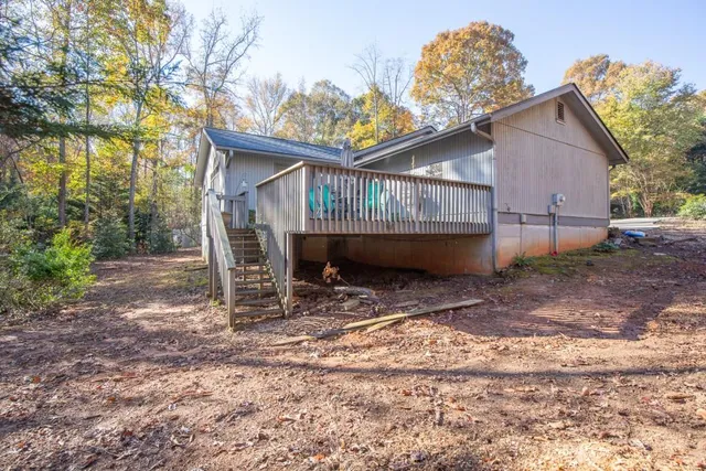 a view of a house with a yard next to a road