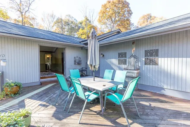 a view of a chairs and table in patio of the house