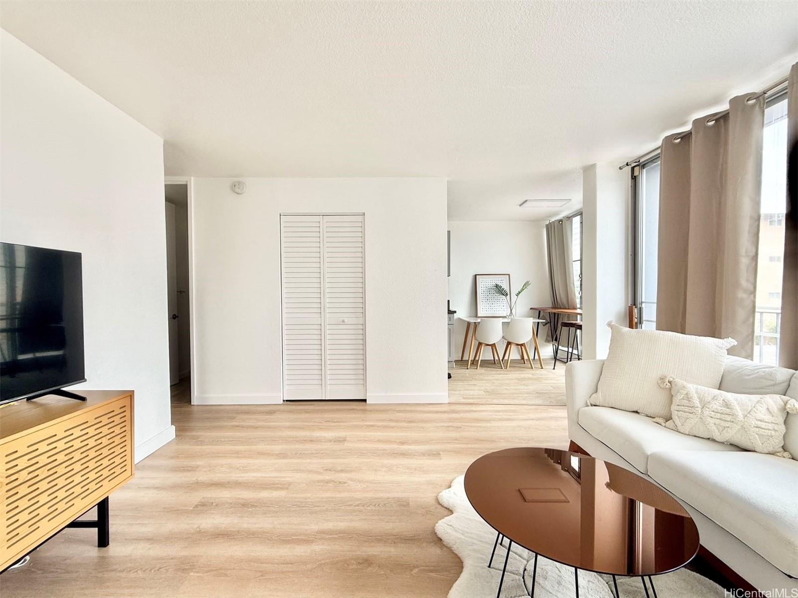 1456 Thurston Avenue, Unit A204 Honolulu, HI 96822 - Photo 1 of 12 a living room with furniture and a flat screen tv