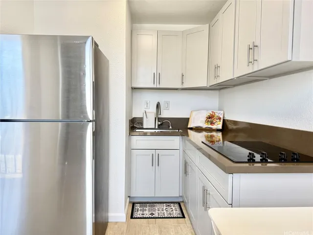 a kitchen with a refrigerator and cabinets