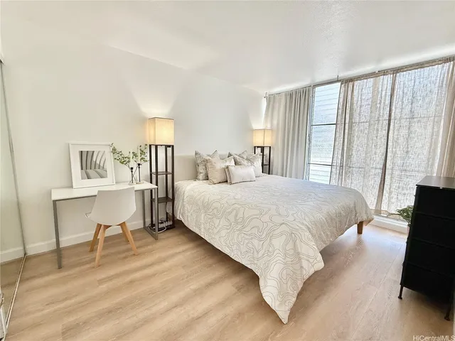 a bedroom with a bed a table and chair