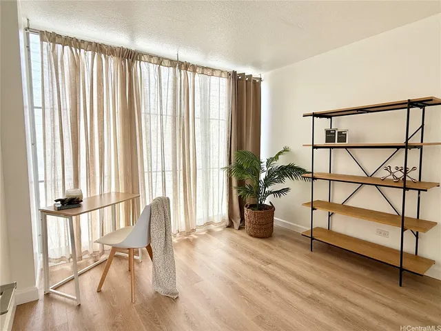 a view of entryway with wooden floor and windows