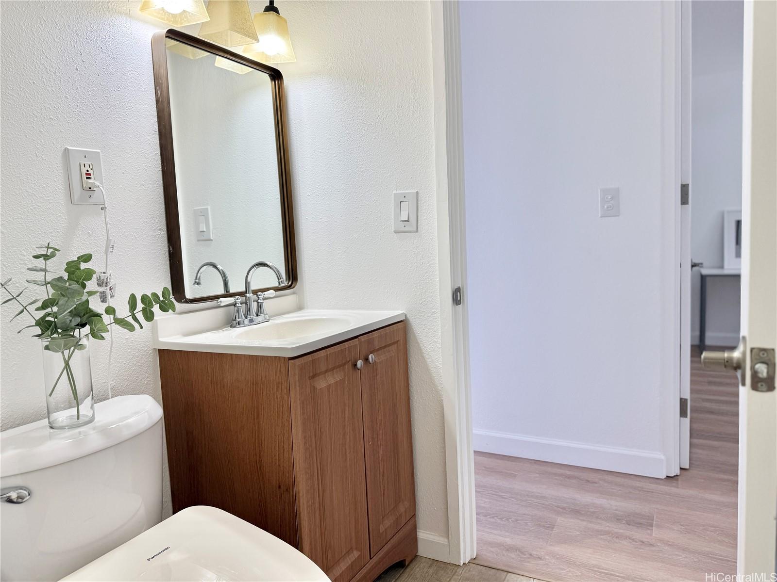 1456 Thurston Avenue, Unit A204 Honolulu, HI 96822 - Photo 10 of 12 a bathroom with a sink vanity mirror and toilet