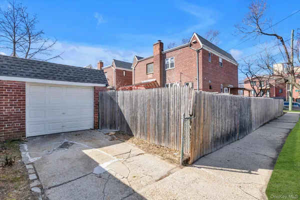 a view of a house with a wooden fence