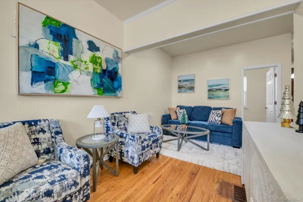 a living room with furniture and painting on the wall