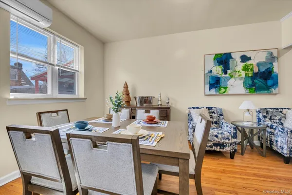 a dining room with furniture and wooden floor