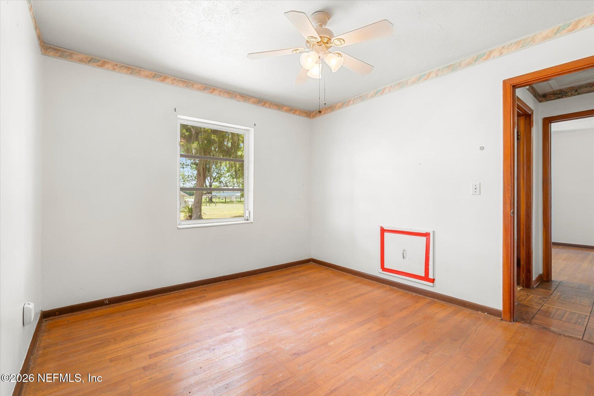 786 West River Road Palatka, FL 32177 - Photo 20 of 53 an empty room with a window and a ceiling fan