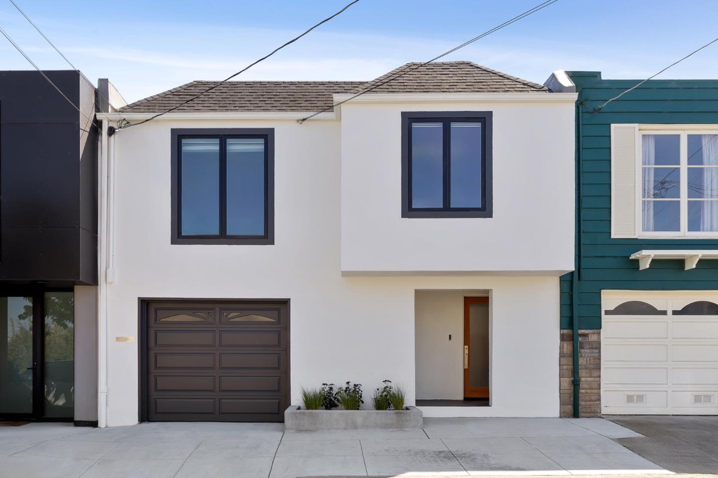 a front view of a house with garage