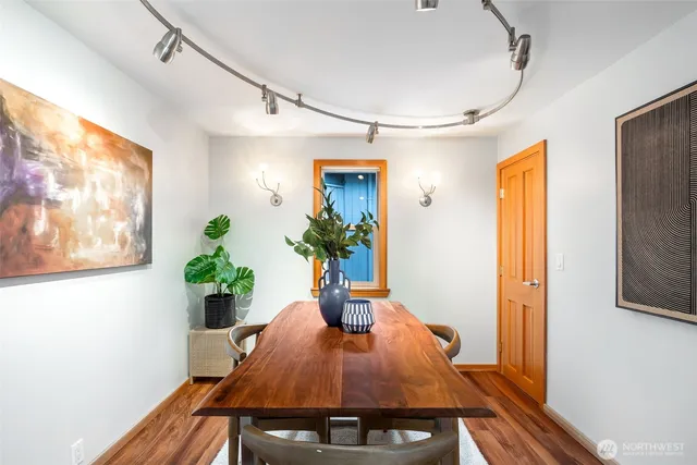 a dining room with furniture and potted plant