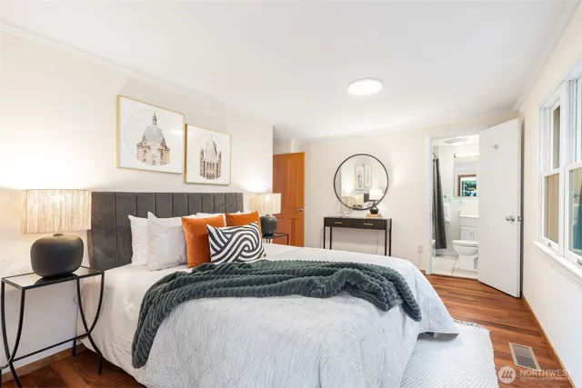 a bedroom with a bed and glass table
