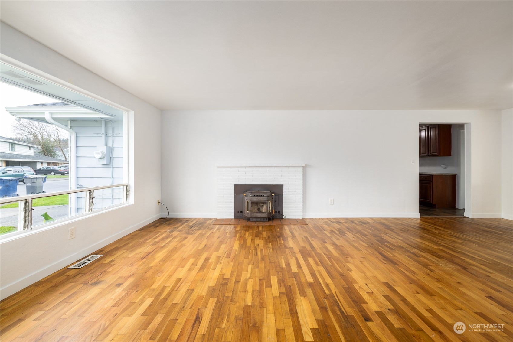 422 Simons Avenue Burlington, WA 98233 - Photo 5 of 21 a view of empty room with wooden floor and fireplace