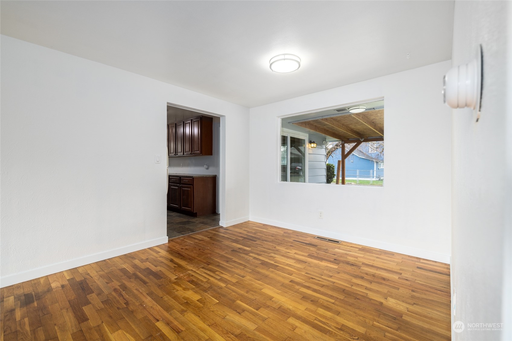 422 Simons Avenue Burlington, WA 98233 - Photo 8 of 21 a view of an empty room with wooden floor and a window