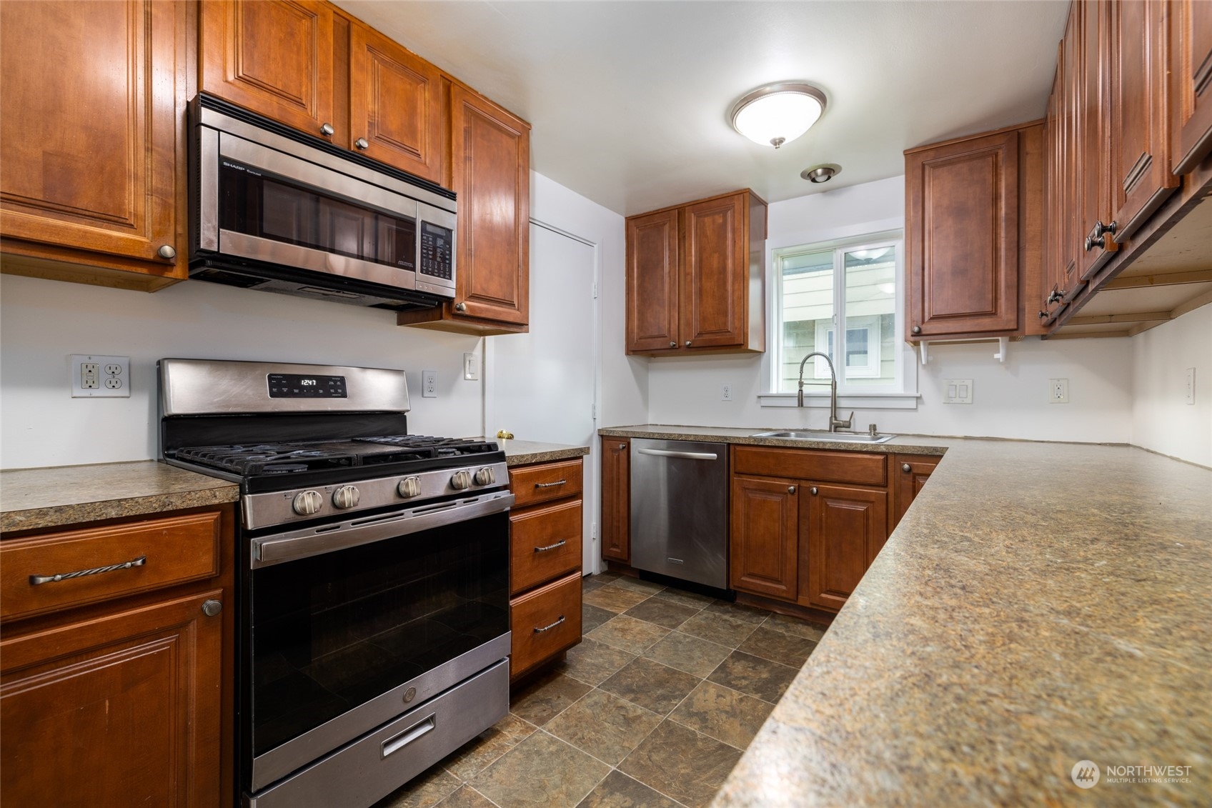 422 Simons Avenue Burlington, WA 98233 - Photo 10 of 21 a kitchen with stainless steel appliances granite countertop a stove microwave and sink