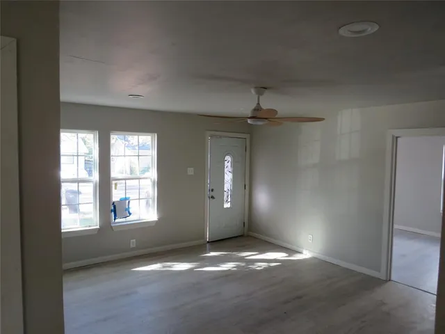 an empty room with windows and entrance