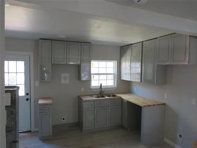 a kitchen with a sink cabinets and window