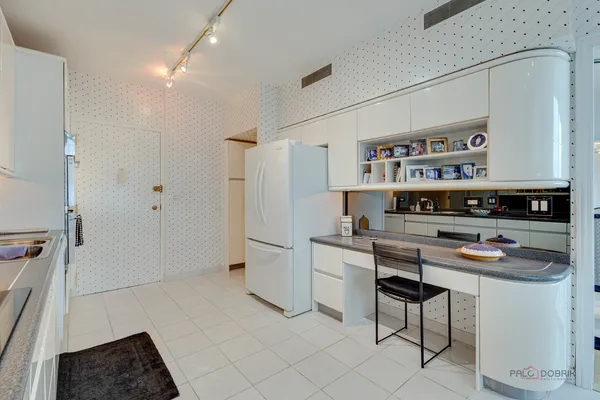 a kitchen with stainless steel appliances a refrigerator and a stove top oven