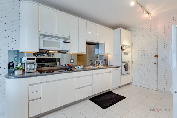 a kitchen with stainless steel appliances a sink a stove a microwave and cabinets