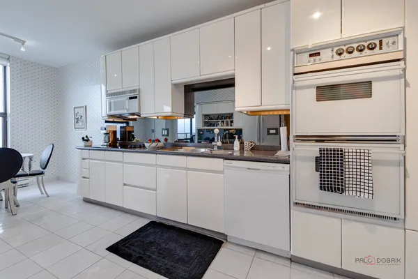 a kitchen with stainless steel appliances a stove a sink and cabinets