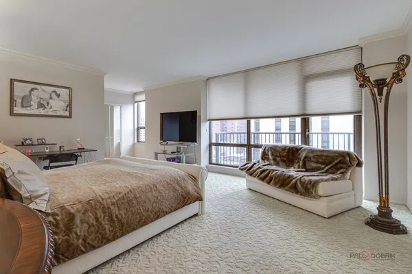 a spacious bedroom with a bed and a couch