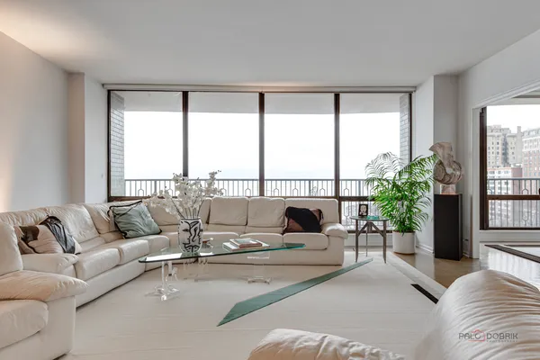 a living room with furniture and a large window