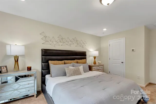 a bedroom with bed and a night stand