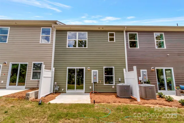 a backyard of a house with yard outdoor seating and barbeque oven