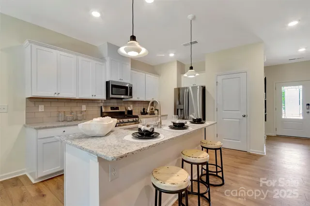 a kitchen with a sink a microwave a stove and refrigerator