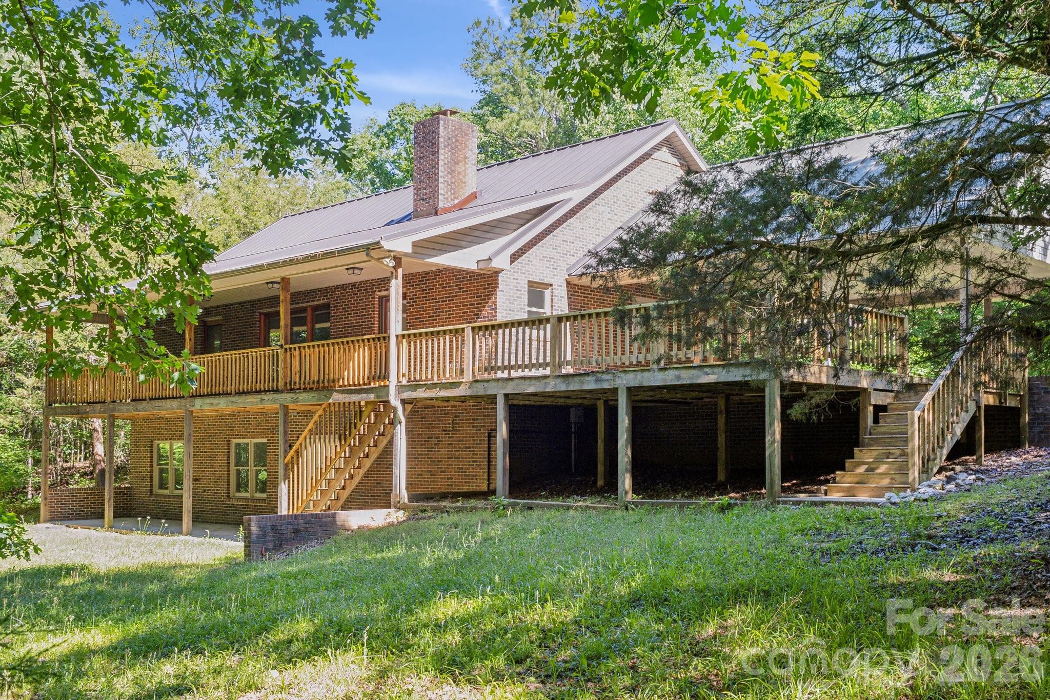 3090 Goblet Road Richburg, SC 29729 - Photo 1 of 48 a view of a house with a large window and a yard with plants and large tree