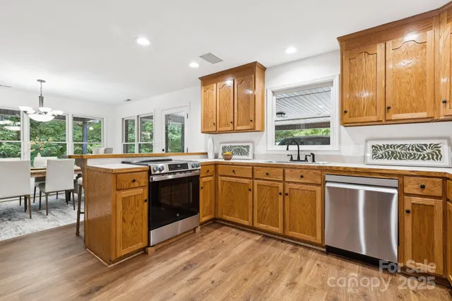 a kitchen with a sink cabinets and wooden floor