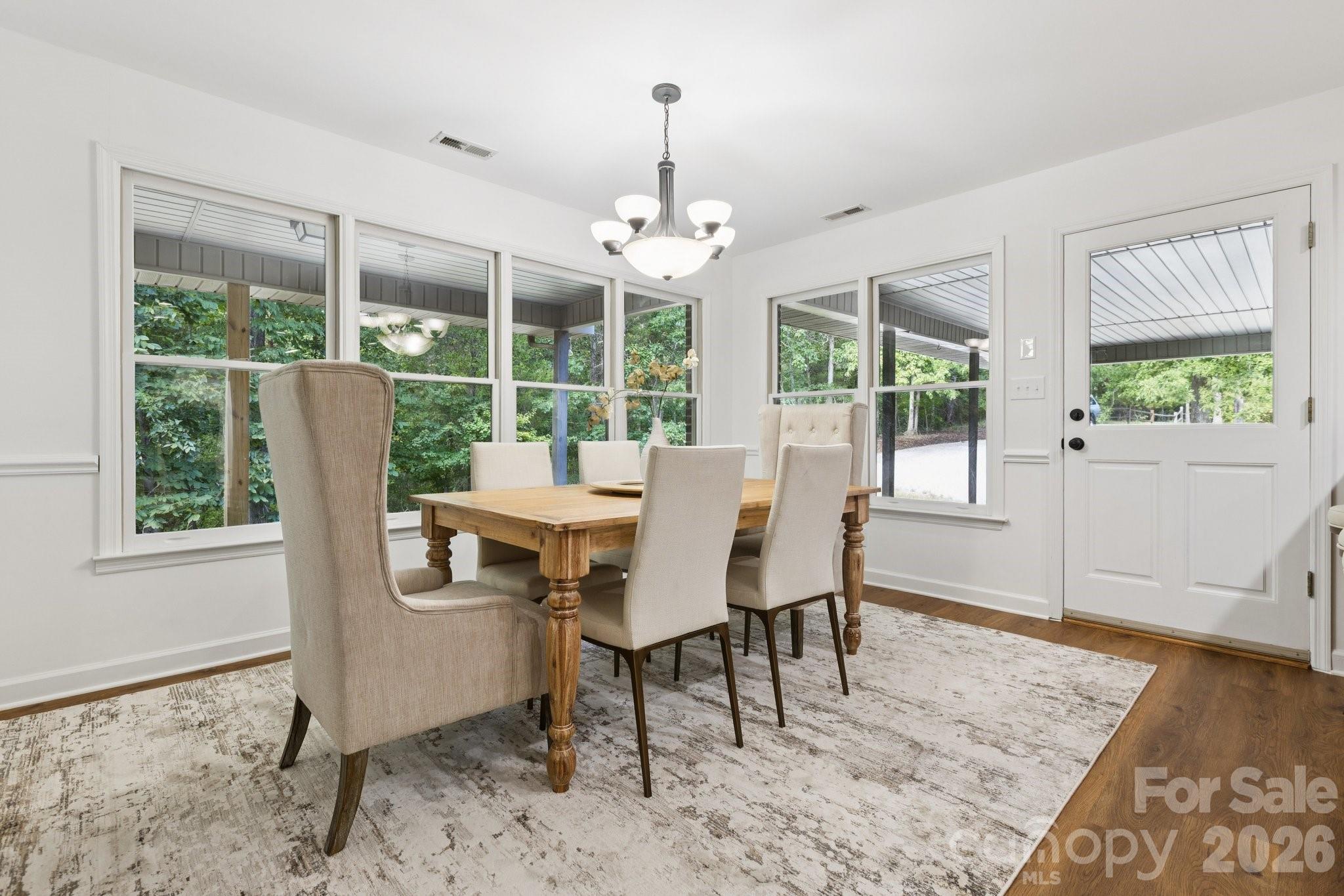 3090 Goblet Road Richburg, SC 29729 - Photo 12 of 48 a dining room with furniture a chandelier and wooden floor