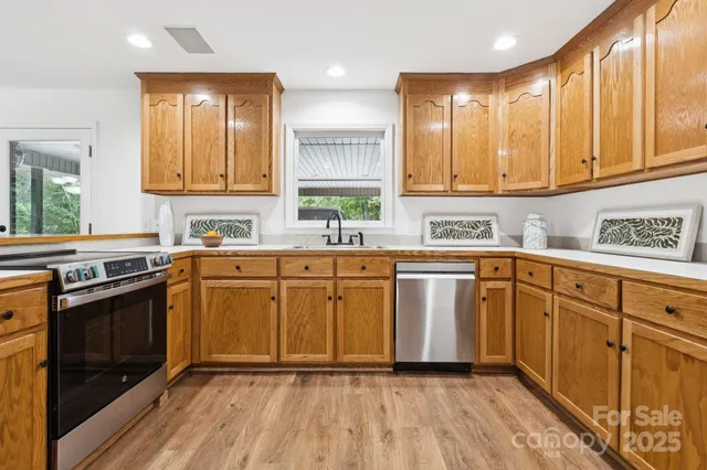 a kitchen with a sink stove and cabinets