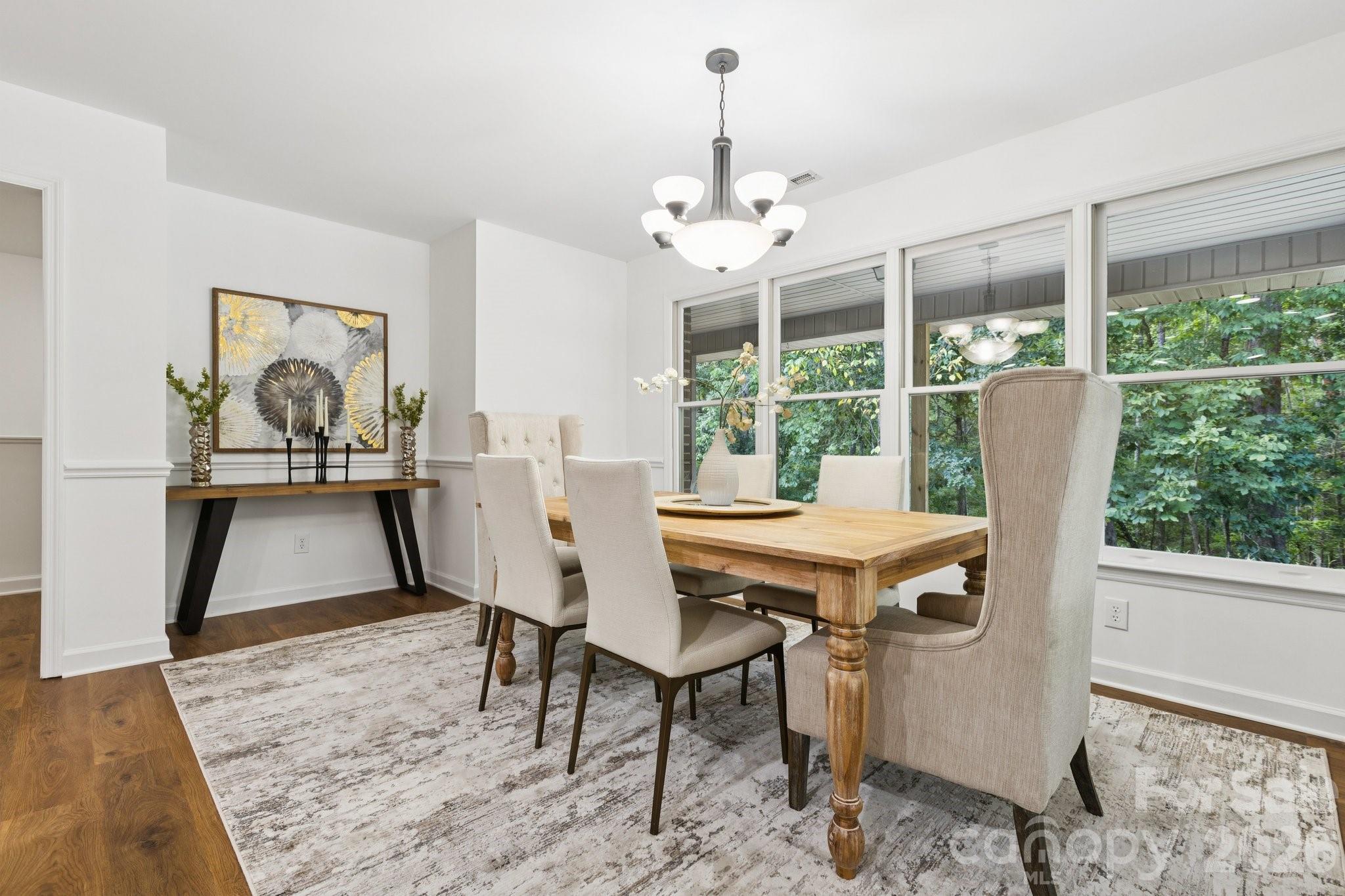 3090 Goblet Road Richburg, SC 29729 - Photo 13 of 48 a dining room with furniture a chandelier and wooden floor