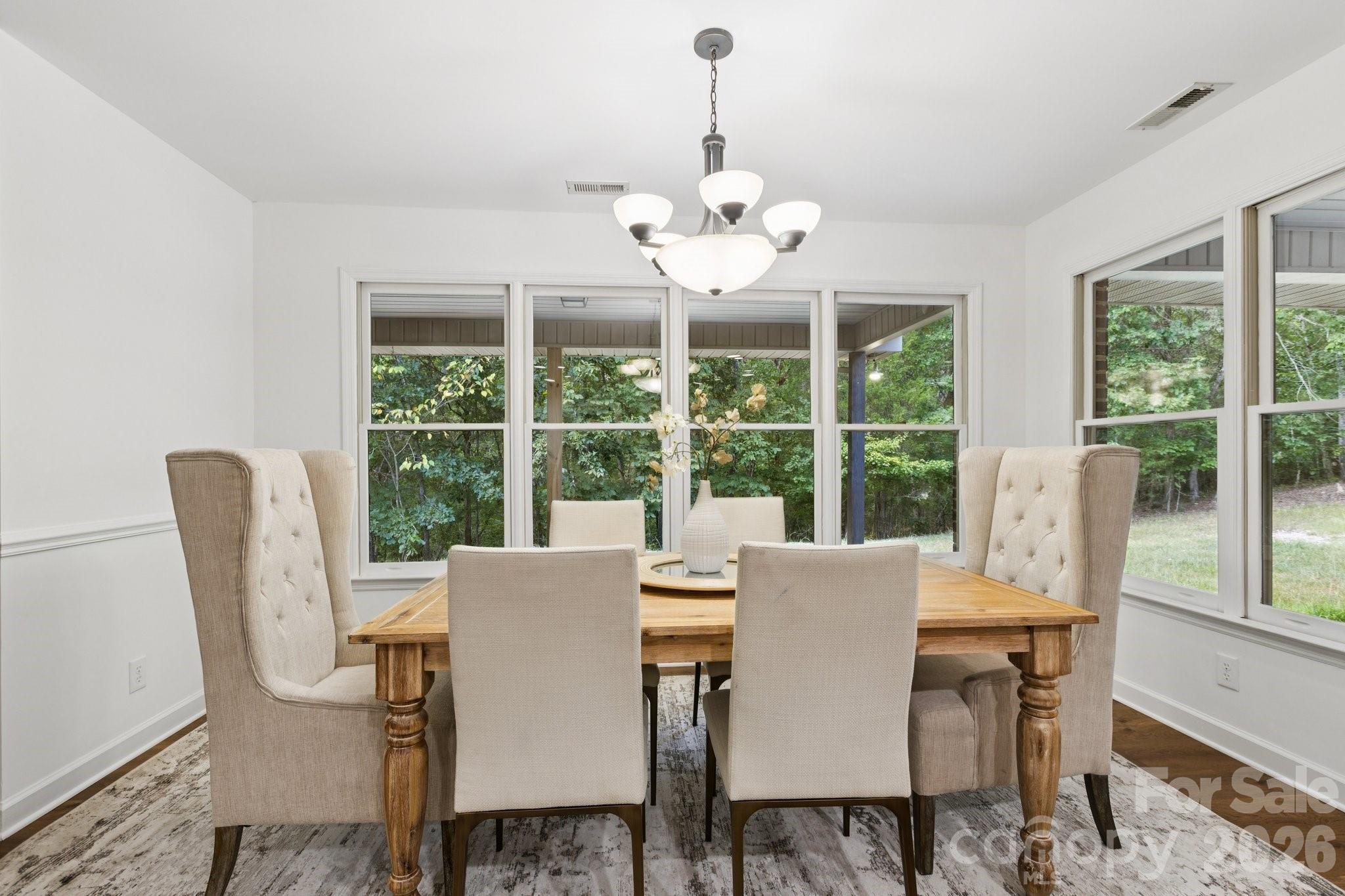 3090 Goblet Road Richburg, SC 29729 - Photo 15 of 48 a view of a dining room with furniture large windows and wooden floor