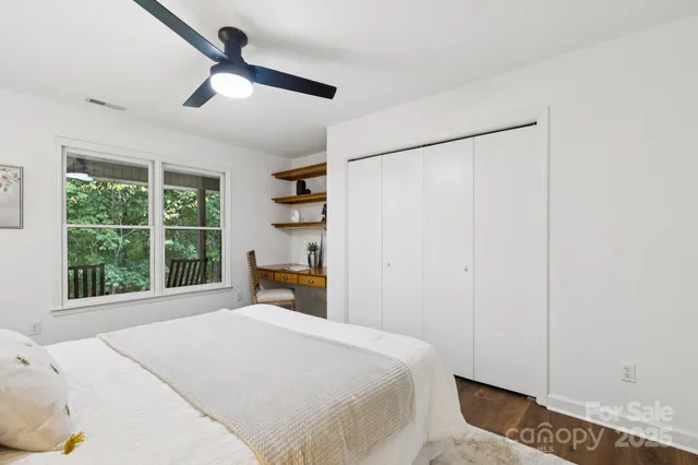 a bedroom with a large bed and a large window