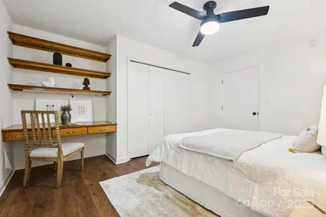 a bedroom with a bed and a table in it