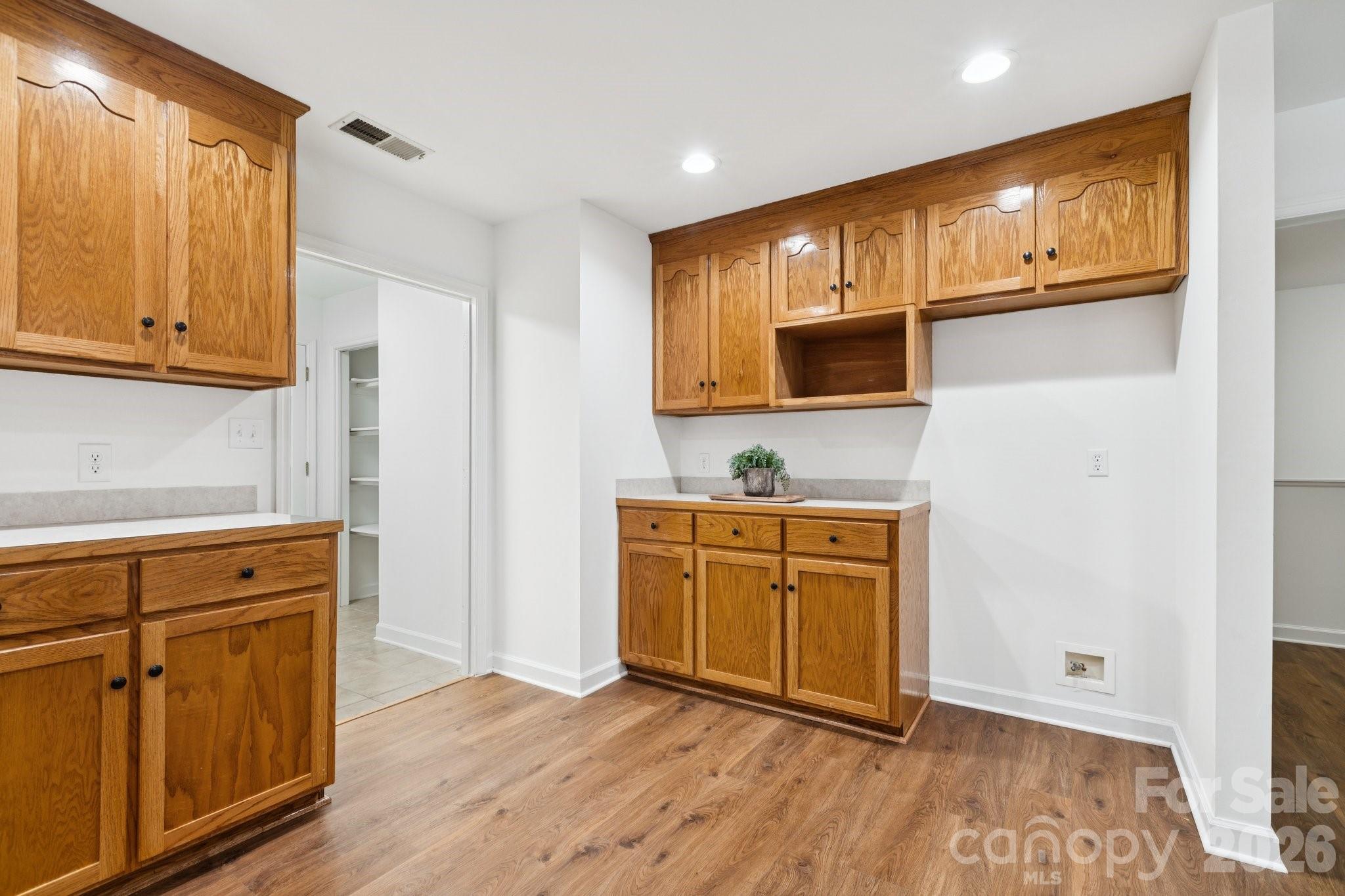 3090 Goblet Road Richburg, SC 29729 - Photo 20 of 48 a kitchen with stainless steel appliances granite countertop a refrigerator a sink dishwasher and wooden cabinets with wooden floor
