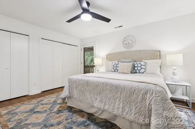 a bedroom with a bed and a ceiling fan