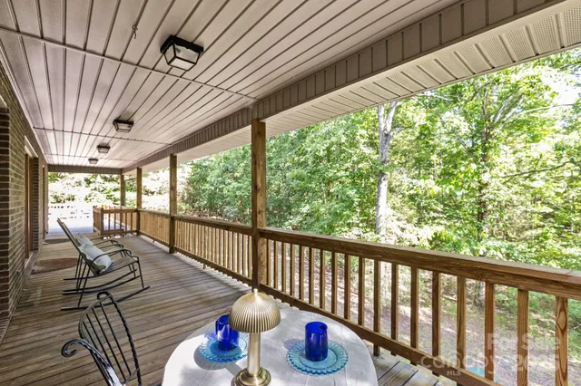 a view of a patio with wooden floor chairs