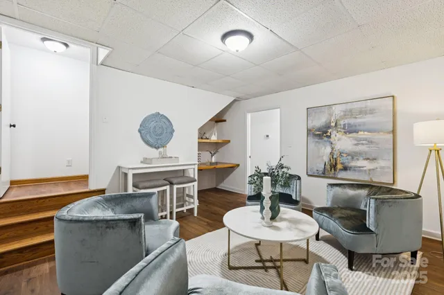 a living room with furniture and a clock