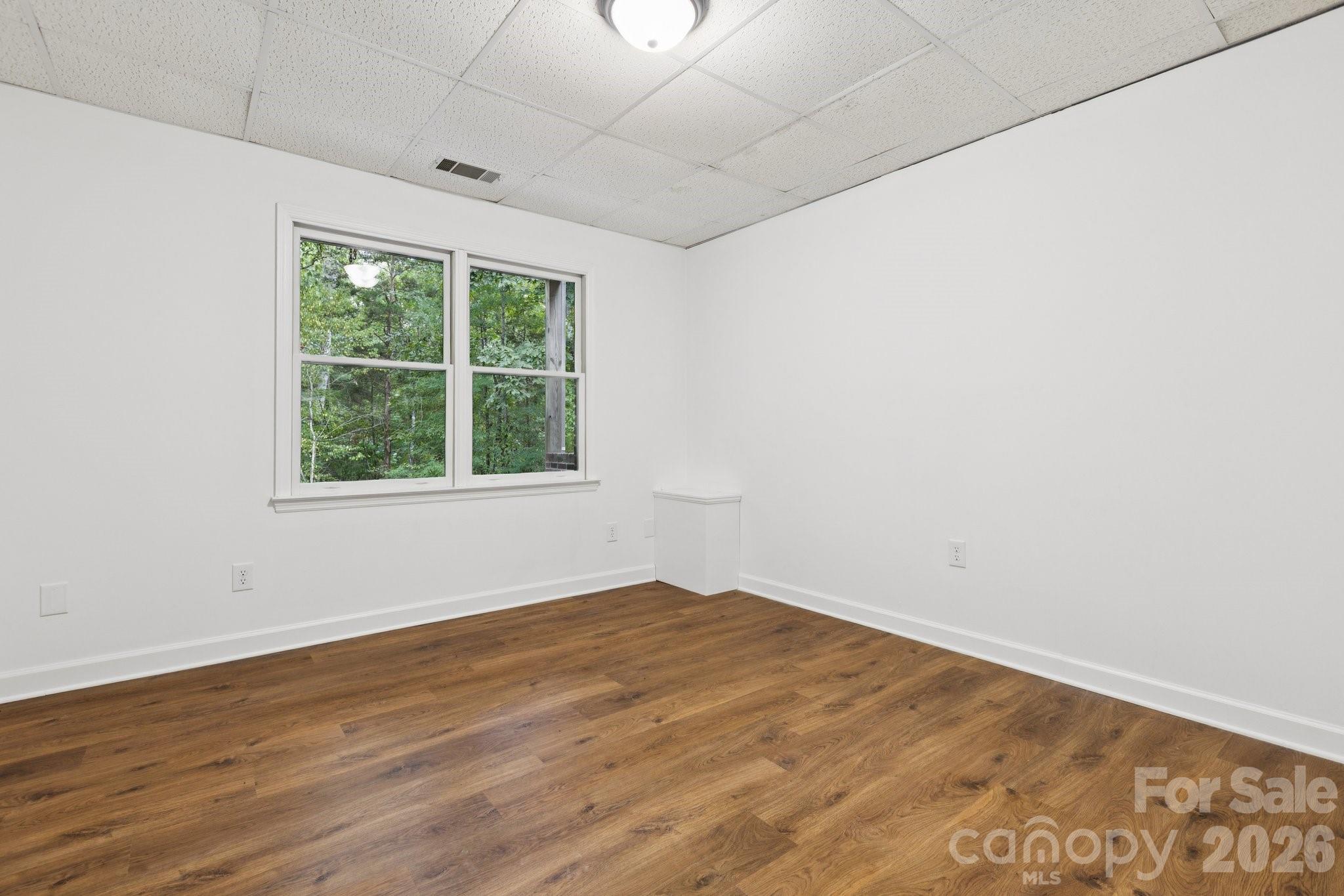 3090 Goblet Road Richburg, SC 29729 - Photo 40 of 48 an empty room with wooden floor and windows