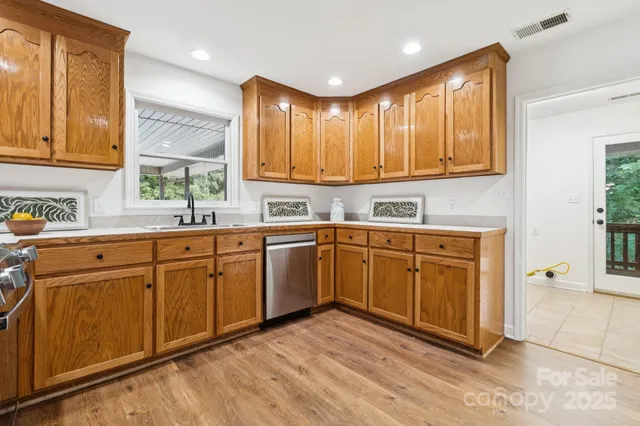 a kitchen with cabinets a sink and appliances
