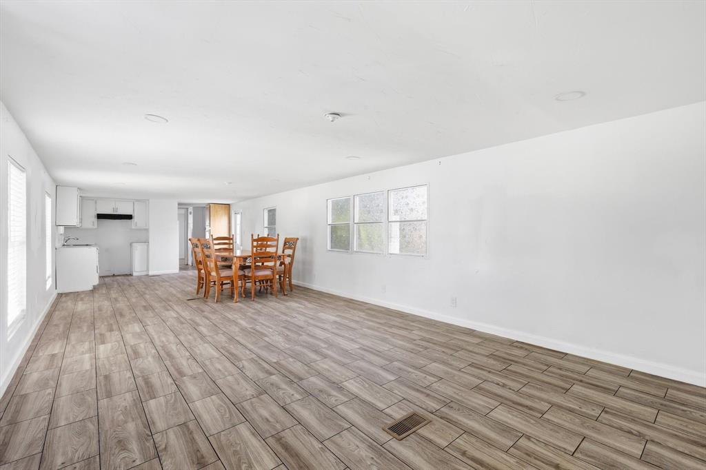 316 Summit Drive Springtown, TX 76082 - Photo 7 of 39 The property features an expansive open concept living area with wood-look tile flooring