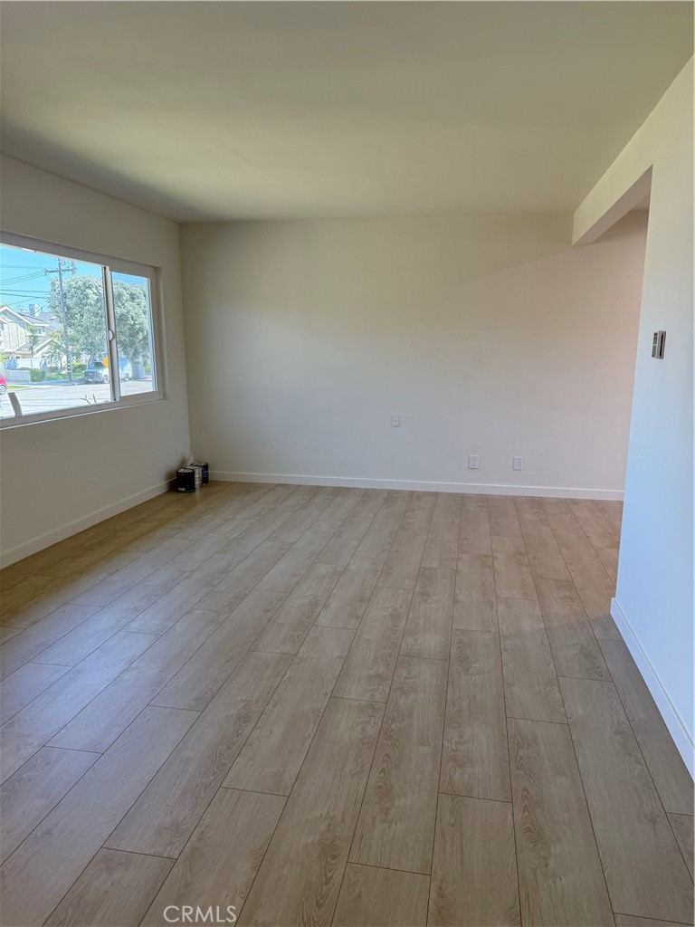 717 Naramore Way Redondo Beach, CA 90278 - Photo 5 of 16 an empty room with wooden floor and windows